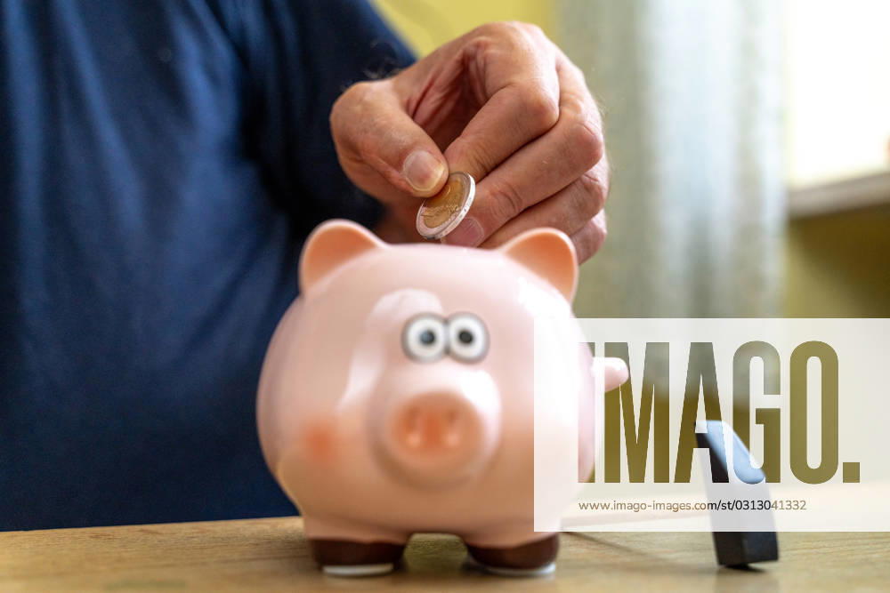 An old man throws euro coins into a piggy bank. Retirement provision concept