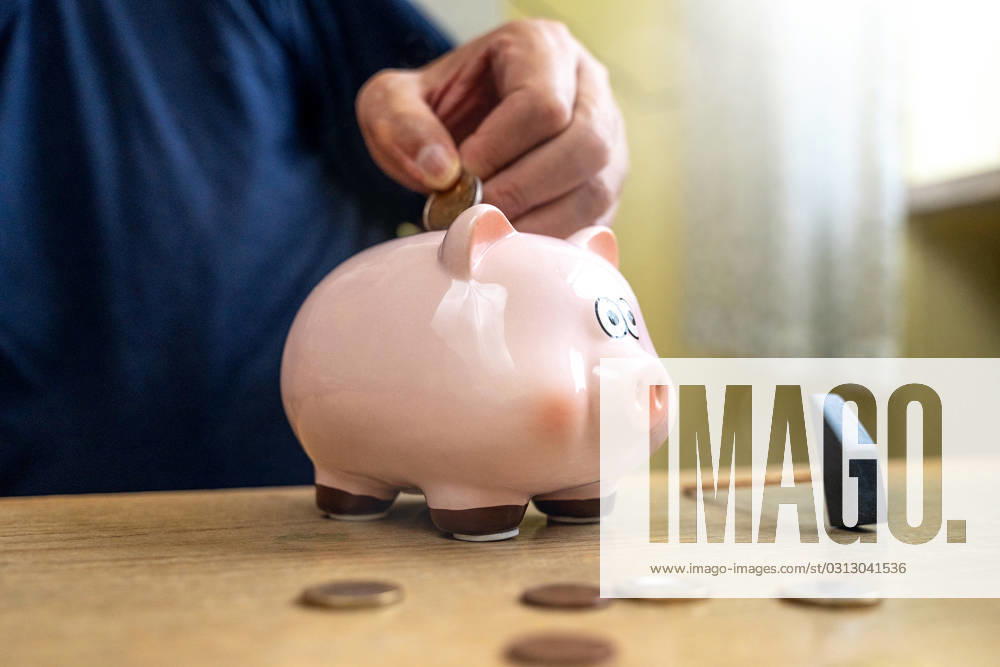 An old man throws euro coins into a piggy bank. Retirement provision concept