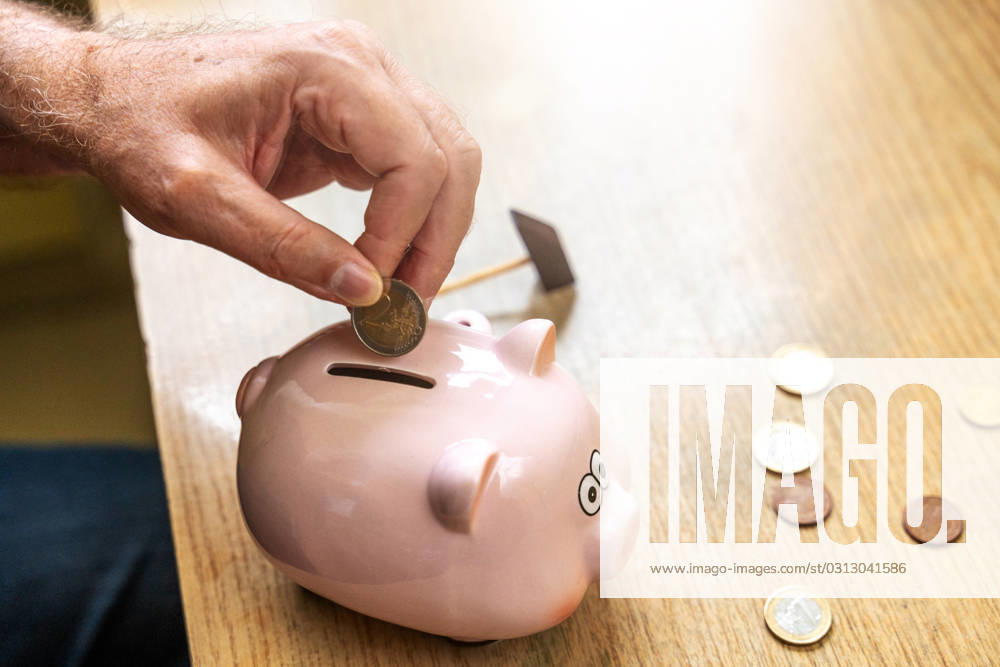 An old man throws euro coins into a piggy bank. Retirement provision concept
