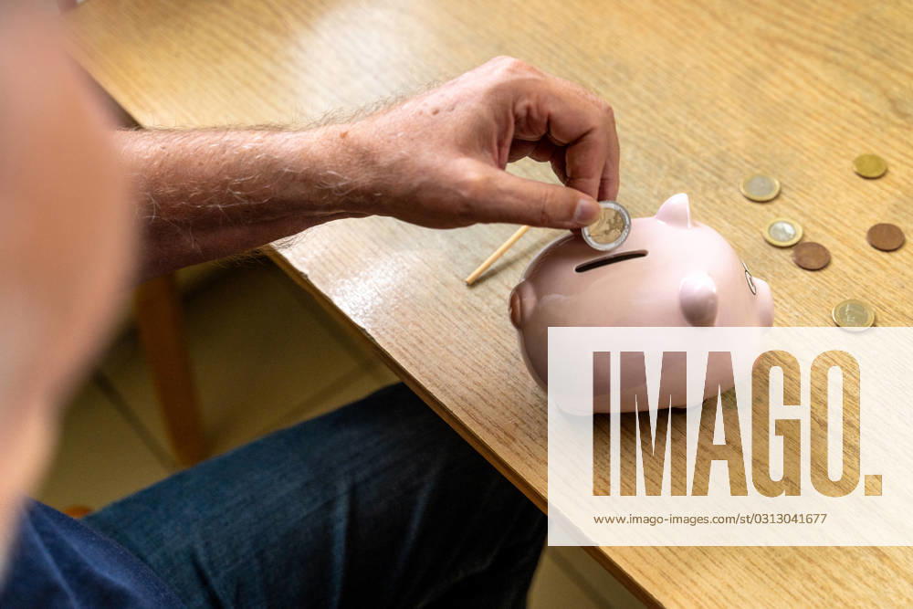 An old man throws euro coins into a piggy bank. Retirement provision concept