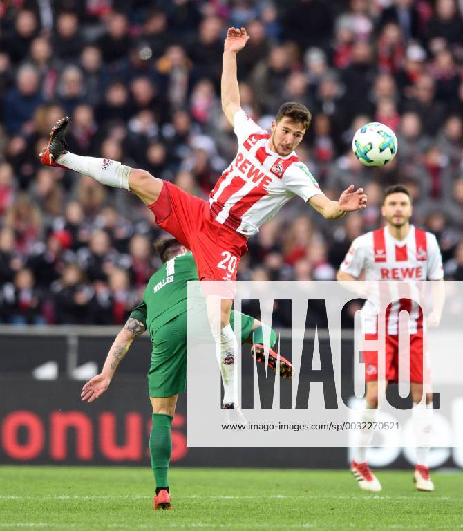 - SPORT 1. FC Köln - FC Augsburg 27.01.2018. Salih Özcan (Köln) fliegt über Marcel Heller (FCA).