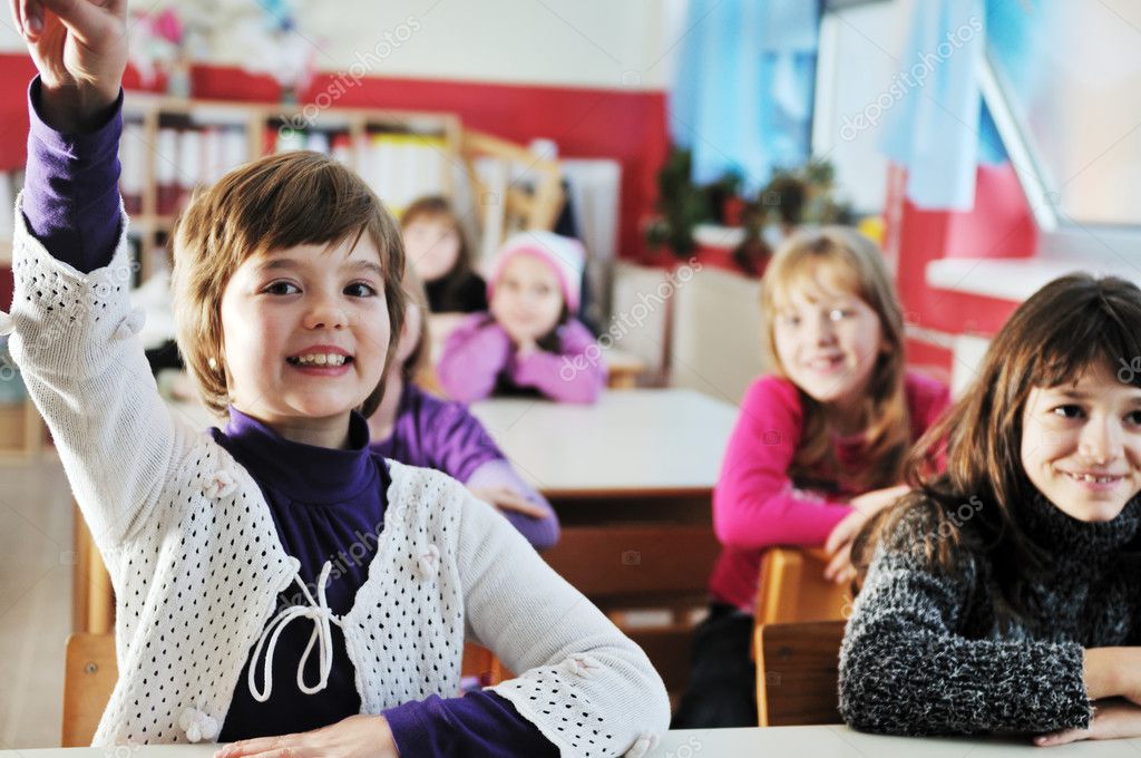 Happy young teacher woman at elementrary school teaching and giving leassons to group of young smart children model released