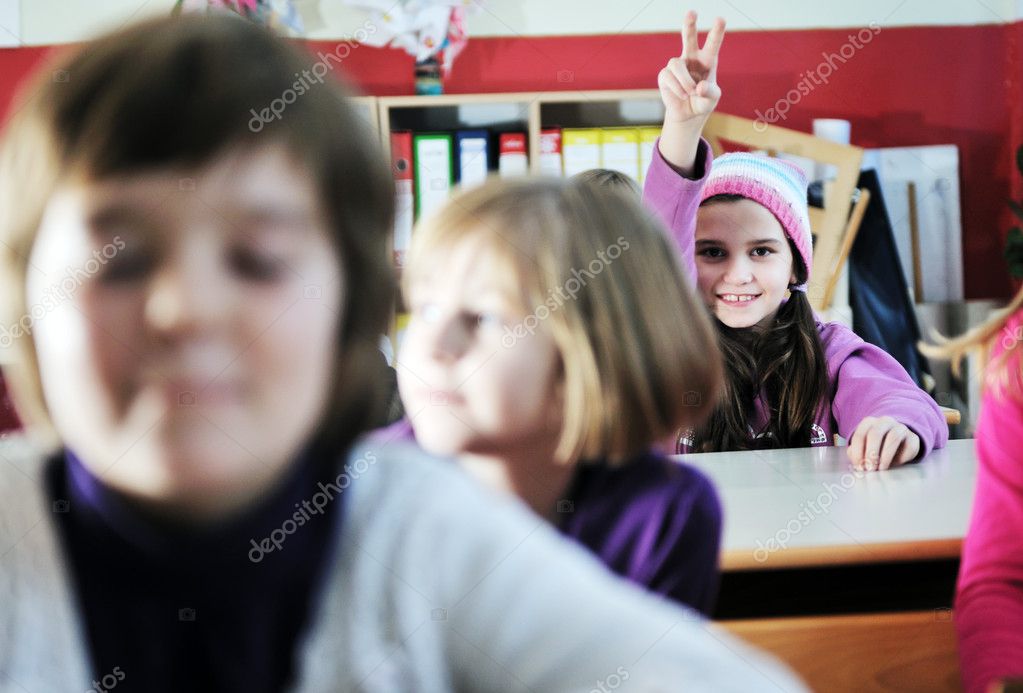 Happy young teacher woman at elementrary school teaching and giving leassons to group of young smart children model released