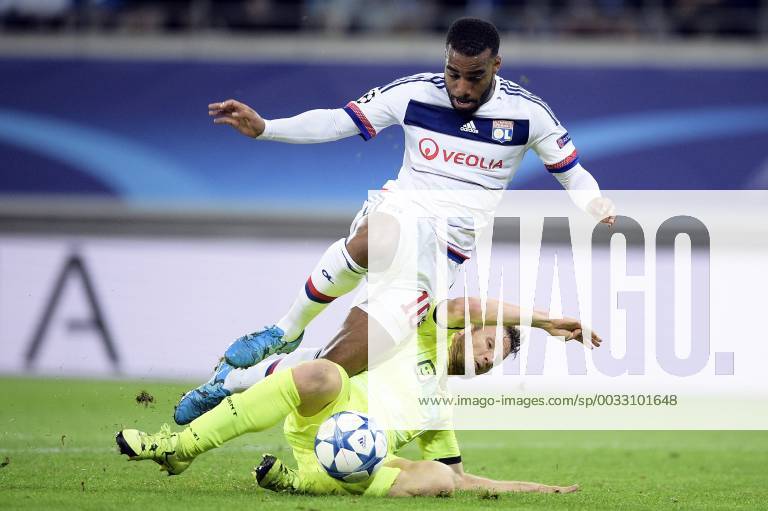 - GENT, BELGIUM: Lyon s Alexandre Lacazette and Gent s Lasse Nielsen fight for the ball during the first game in the group stage of the Uefa Champions League competition, in group H, between Belgian first league soccer team KAA Gent and Olympique Lyon, in Gent, Wednesday 16 September 2015. YORICKxJANSENS x85280468x