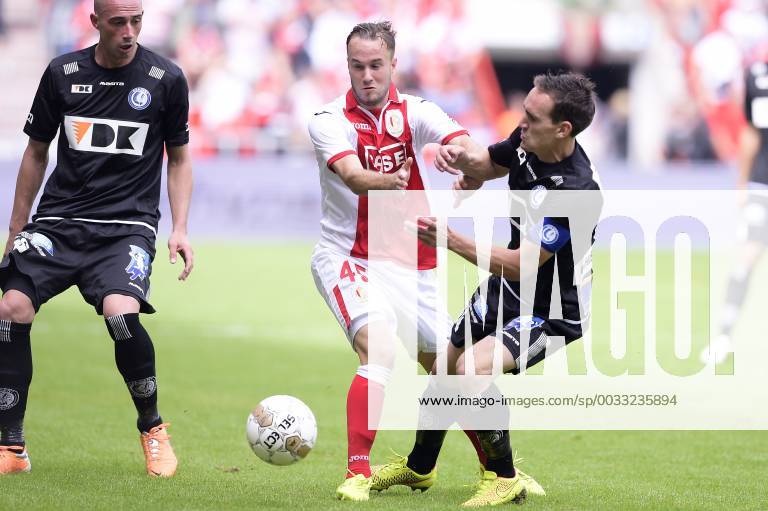- LIEGE, BELGIUM: Standard d Francois Marquet and Gent s Sven Kums fight for the ball during the Jupiler Pro League match between Standard de Liege and AA Gent, in Liege, Sunday 10 August 2014, on the third day of the Belgian soccer championship. YORICKxJANSENS x61000211x