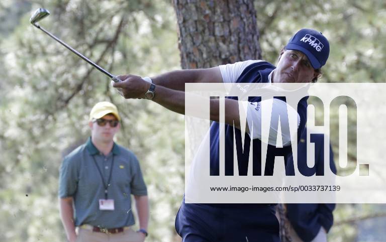 Phil Mickelson hits his second shot from out of the pine straw to the 1st hole in the 2nd round of the 2018 Masters Tournament at the Augusta National Golf Club in Augusta, Georgia, on April 6, 2018. AUG20180406106 JOHNxANGELILLO