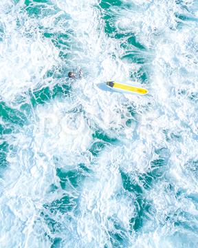 An overhead vertical shot of a surfer with a yellow surfboard in a blue sea sea, surfboard, ocean, surfer, surf, surfing, beach, wave, summer, blue, sport, travel, water, vacation, tropical, nature, extreme, board, outdoor, hawaii, fun, active, lifestyle, beautiful, holiday, activity, man, action, shore, background, sky, male, people, sunset, young, adventure, sun, sand, coast, splash, bali, relax, female, sunny, landscape, holding, recreation, vintage, silhouette, palm