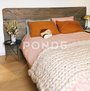 An interior of a beautiful bedroom with a pink bed cover with plant on the left room, bedding, cozy, bedroom, interior, wooden, pink, furniture, white, pillow, morning, bed, tray, quilt, covered couch, design, romantic, home, breakfast, house, lifestyle, hotel, closeup, litter, brown, lamp, background, bedclothes, spring, luxury, cup, sofa, beautiful, decor, rest, summer, coffee, modern, nature, relax, conveyance, woman, comfortable, mood, sleep, lazy, cloth covering, concept, comfort, apartment