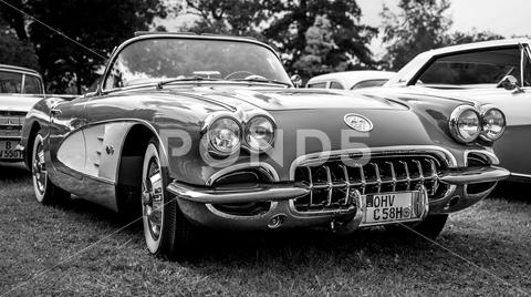 The sports car Chevrolet Corvette (C1), 1958. Black and white. The exhibition of "US Car Classics". chrome, diedersdorf, 2-door, america, american, ancient, antique, auto, automobile, automotive, black, c1, cabrio, cabriolet, car, chevrolet, classic, convertible, corvette, design, front, germany, iconic, model, nostalgia, old, oldtimer, retro, shine, sports car, style, transport, us, usa, vehicle, vette, vintage, white