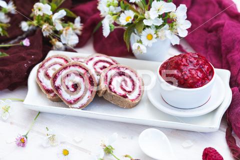 An amazing view of tasty looking raspberry rolls and raspberry jam put on a white plate dessert, sweet, raspberry, food, fruit, delicious, berry, fresh, tasty, healthy, cream, gourmet, cake, table, background, homemade, summer, closeup, blueberry, snack, breakfast, sugar, portion, recipe, plate, decorated, ingredient, natural, freshness, pastry, cuisine, organic, diet, cafe, berries, yummy, eat, restaurant, syrup, jam, liquid, red, cup, ceramic, selective focus, roll, flower, plant, wooden, vegan