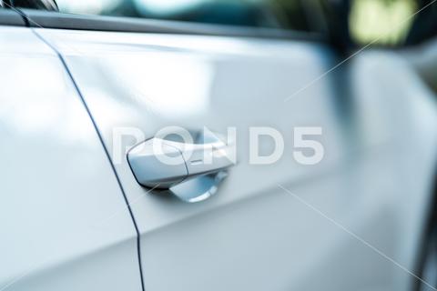 Closeup of a bright car door. Concept for a modern car. Perfect to illustrate new mobility, car purchase or electric vehicles. car, door, vehicle, transportation, automobile, auto, transport, design, white, style, luxury, new, travel, modern, drive, metal, window, wheel, road, business, open, speed, background, motor, street, city, people, technology, automotive, isolated, view, germany, shiny, beautiful, concept, future, new ways, self driving, innovation, munich, bavaria, closeup, detail, enter, buy, electronic, e-mobility, electric, emission, power