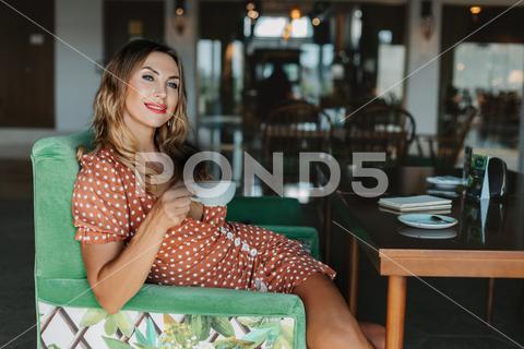 Portrait of a young woman drinking coffee and enjoying her free time during a work break. cafe, coffee, woman, time, break, leisure, portrait, gorgeous, young, work, lunch, tea, drinking, alone, looking, business, girl, breakfast, relax, person, attractive, drink, restaurant, lifestyle, one, pretty, beautiful, beverage, cup, dreaming, sitting, indoor, food, enjoying aroma, hair, enjoy, brunch, positive, caffeine, cozy, holding, modern, happy, table, rest