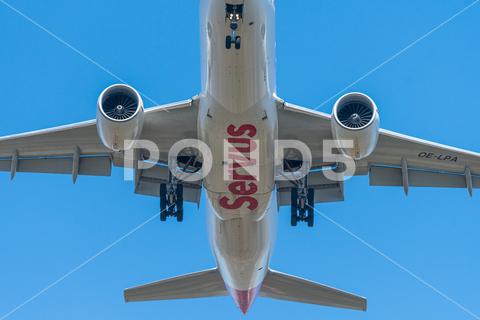 Airplane on landing approach on a sunny day in spring, blue sky, sunny day in spring airliner, jet, plane, approach, travel, sky, aerodrome, flight, fly, touchdown, flying, blue skies, vehicle, transport, wing, landing, airline, aeroplane, aviation, aircraft, journey, aerial, passenger, appearance, industry, air, power, descent, business, wheel, blue, undercarriage, speed, open air, engine, powerful, vacation, arrival, land, loud, white, landing gear, environment, noise, destination