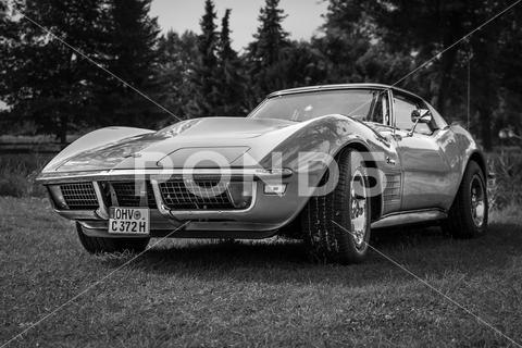 The sports car Chevrolet Corvette Stingray Coupe, 1972. Black and white. The exhibition of "US Car Classics". machine, chrome, ancient, antique, auto, automobile, car, design, germany, history, nostalgia, old, oldtimer, retro, transport, vehicle, vintage, Diedersdorf, US, USA, America, classics, 2-door, sports car, Chevrolet, Corvette, Stingray, Coupe, black, white
