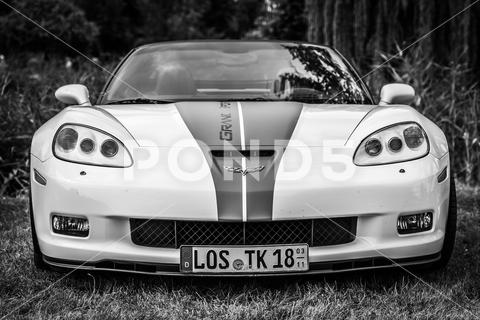 The sports car Chevrolet Corvette Grand Sport Convertible. Black and white. The exhibition of "US Car Classics". power, technology, performance, modern, 2-door, america, american, ancient, antique, auto, automobile, automotive, black, c6, cabrio, cabriolet, car, chevrolet, classic, convertible, corvette, design, diedersdorf, engine, exhibition, front, general motors, germany, gm, grand sport, machine, model, muscle car, nostalgia, old, oldtimer, retro, sports car, style, transport, transportation, us, usa, vehicle, white