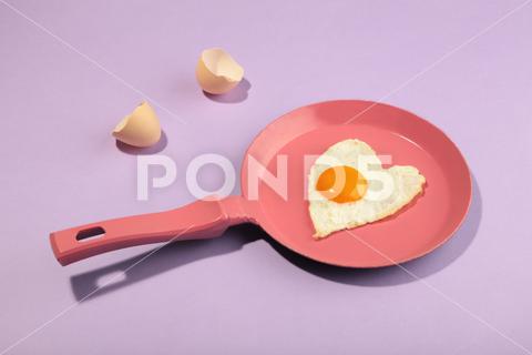 Pink frying pan and egg in heart shape. Valentine's day pan, food, egg, minimal, background, idea, concept, design, abstract, white, creative, pastel, cooking, cook, morning, cooked, fry, breakfast, egg shell, cholesterol, yellow, yolk, meal, health, bright, hipster, color, funky, fun, kitchen, copy space, farm, nutrition, protein, cast, table, easter, motion, restaurant, event, minimalism, pink, heart, lunch, blue, art, raw, frying, vertical, broken, Mykolaiv, Mykolaiv Oblast, Ukraine, No People