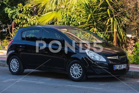 Side; Turkey March 03 2022: black Opel Corsa is parked on the street on a warm day alanya, april, asphalt, auto, automobile, automotive, car, city, compact car, concept, corsa, design, drive, editorial, engine, european, fast, future, germany, highway, industry, january, model, modern, nature, new, opel, opel car, opel corsa, power, road, side, street, sundown, technology, tourism, traffic, transport, transportation, travel, turkey, vehicle, way, wheel