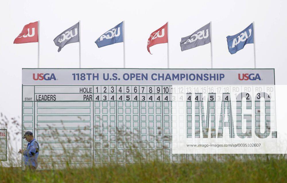 USGA flags fly above a leaderboard with no entries on it on the Wednesday before the 118th U.S. Open Championship at Shinnecock Hills Golf Club in Southampton, New York on June 13, 2018. NYP20180613301A JOHNxANGELILLO