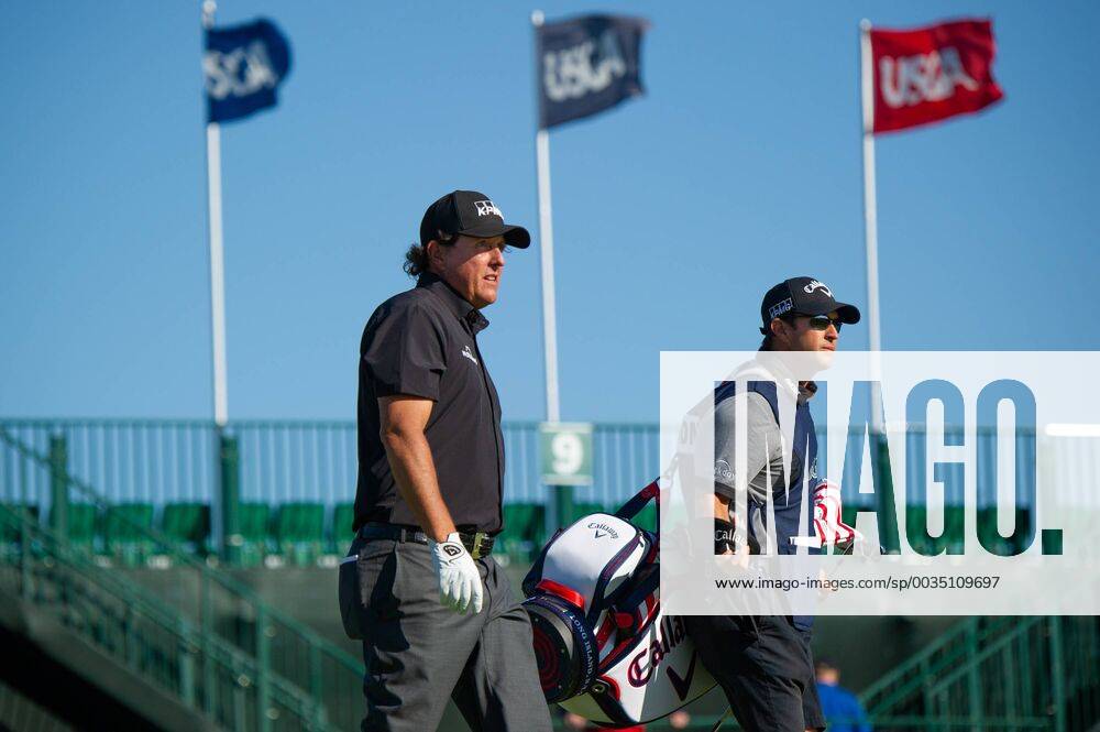 Phil Mickelson from the United States and caddy Tim Mickelson walk on the 10th fairway in the first round of the 118th U.S. Open Championship at Shinnecock Hills Golf Club in Southampton, New York on June 14, 2018. NYP20180614109 COREYxSIPKIN