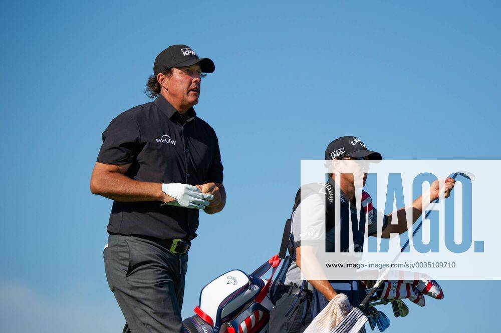 Phil Mickelson with caddy Tim Mickelson walk on the 11th fairway in the first round of the 118th U.S. Open Championship at Shinnecock Hills Golf Club in Southampton, New York on June 14, 2018. NYP20180614122 COREYxSIPKIN