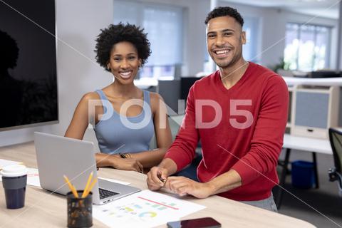 Portrait of happy multiracial male and female advisors with laptop working at office during meeting. unaltered, business, teamwork, modern office and technology concept. Two People, Young Adult, Man, Male, Mixed-Race, Woman, Female, Black, People, Portrait, Happy Multiracial, Male Female, Advisor, Laptop, Working, Office, Meeting, Unaltered, Business, Teamwork, Modern Office, Technology Concept, Computer, Team, Businessman, Professional, Work, Corporate, Businesswoman, Job, Communication, Workplace, Internet, Person, Technology, Finance, Manager, Young, Discussion, Success, Desk, Happy, Multiracial, Modern, Concept
