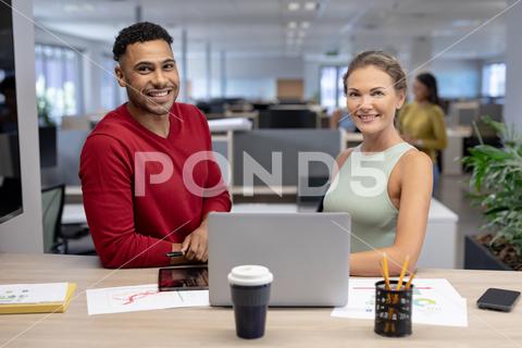 Portrait of happy multiracial male and female advisors with laptop at desk in modern workplace. unaltered, business, teamwork, modern office and technology concept. Four People, Young Adult, Man, Male, Mixed-Race, Woman, Female, Black, Mid Adult, Caucasian, People, Portrait, Happy Multiracial, Male Female, Advisor, Laptop, Desk, Modern Workplace, Unaltered, Business, Teamwork, Office, Technology Concept, Computer, Work, Businessman, Workplace, Internet, Team, Professional, Communication, Corporate, Job, Person, Notebook, Technology, Finance, Young, Meeting, Businesswoman, Adult, Success, Happy, Multiracial, Modern, Concept