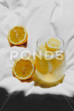 A closeup of a lemon juice with lemons on the bed bed, closeup, lemon, juice, fruit, glass, fresh, food, drink, citrus, cocktail, healthy, yellow, background, sweet, summer, slice, beverage, white, cold, tropical, vitamin, organic, diet