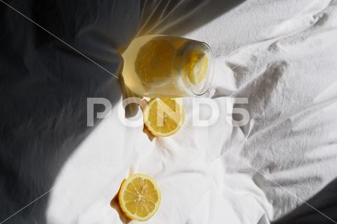 A closeup of a lemon juice with lemons on the bed bed, closeup, lemon, juice, fruit, glass, fresh, food, drink, citrus, cocktail, healthy, yellow, background, sweet, summer, slice, beverage, white, cold, tropical, vitamin, organic, diet