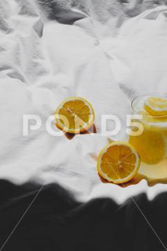 A closeup of a lemon juice with lemons on the bed bed, closeup, lemon, juice, fruit, glass, fresh, food, drink, citrus, cocktail, healthy, yellow, background, sweet, summer, slice, beverage, white, cold, tropical, vitamin, organic, diet