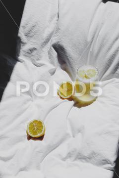 A closeup of a lemon juice with lemons on the bed bed, closeup, lemon, juice, fruit, glass, fresh, food, drink, citrus, cocktail, healthy, yellow, background, sweet, summer, slice, beverage, white, cold, tropical, vitamin, organic, diet