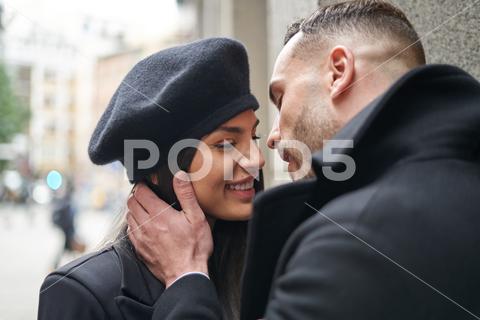 Positive couple in outerwear caressing while standing looking at each other on the street near building during romantic date in city on autumn day couple, love, street, relationship, fondness, date, city, caress, cuddle, romantic, spend time, woman, man, girlfriend, boyfriend, together, outerwear, soulmate, partner, lover, affection, town, bonding, building, beloved, romance, amorous, in love, gentle, leisure, content, style, glad, trust, autumn, amour, tender, positive, valentine, optimist, close, pleasant, spare time, outdoors, looking at each other, smile, happy, delight