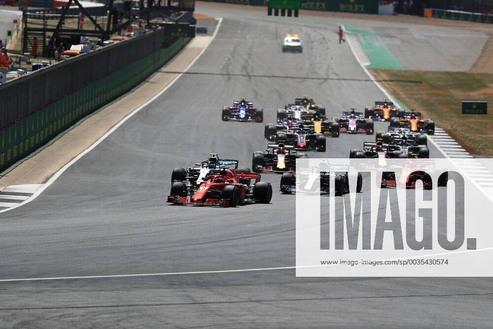 8th July 2018, Silverstone Circuit, Silverstone, England; British Formula One Grand Prix, Race Day; Scuderia Ferrari, Sebastian Vettel leads into Turn 1 ahead of Bottas after Lewis Hamilton has a poor start ActionPlus12045461 Octane