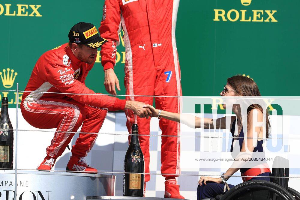 8th July 2018, Silverstone Circuit, Silverstone, England; British Formula One Grand Prix, Race Day; Sebastian Vettel shakes hands with Porsche driver Nathalie McGloin ActionPlus12045579 Octane