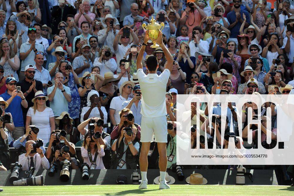 Tennis - 2018 Wimbledon Championships - Week Two, Sunday (Day Thirteen) Men s Singles Final: Kevin Anderson (RSA) vs. Novak Djokovic (SRB) Press Photographers take pictures of Djokovic as he shows off the trophy to the crowd, on Centre Court. COLORSPORT ANDREW COWIE