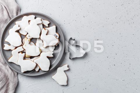 Easter cookies in the shape of a rabbit on a gray plate with gray textiles on a gray background. Copy space easter bunny, rabbit, easter, background, family, design, child, food, girl, spring, sweet, seasonal, cookies, decoration, dessert, tradition, homemade, table, white, holiday, celebration, bake, tray, raw, symbolic, view, making, closeup, cut, rolling pin, cutting, pastry, new, gingerbread, brush, female, shape, flour, wooden, traditional, season, fun, concept, paints, card, childhood, biscuit, top, decor, icing