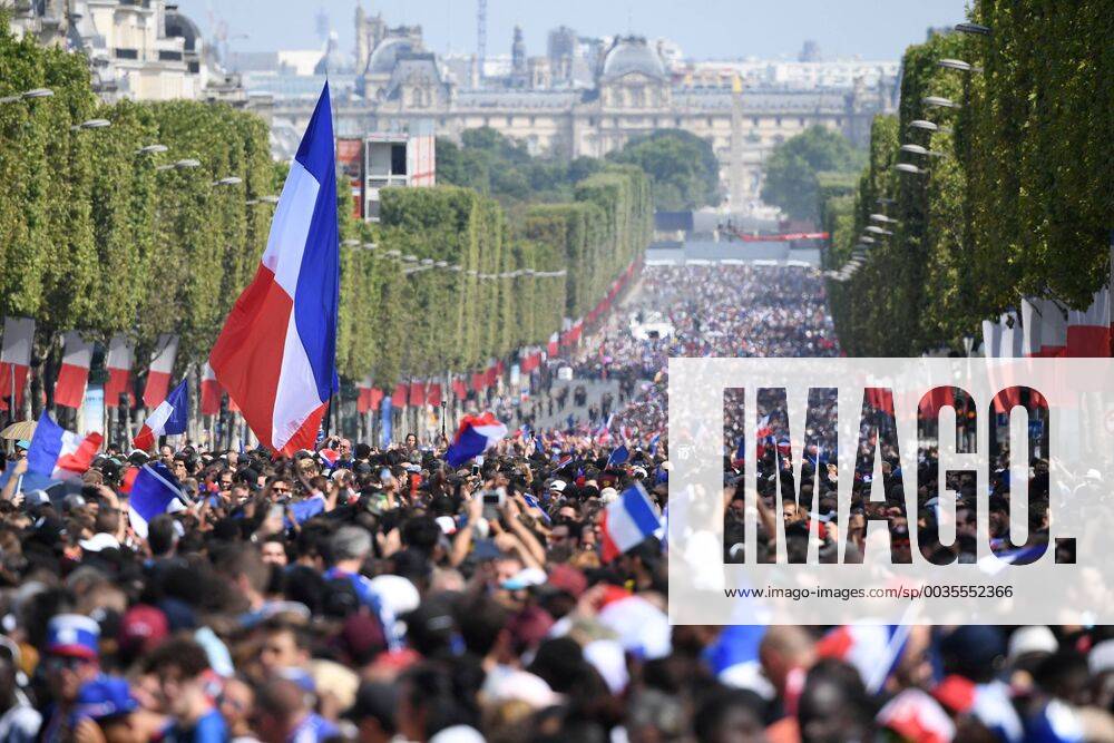 KW29 Supporters wave French national flags while they gather on the Champs-Elysees avenue as they wait for the arrival of the French national soccer team for celebrations after France won the Russia 2018 World Cup final match. Eric Feferberg Pool via Reuters Supporters wave French national flags while they gather on the Champs-Elysees in Paris REUTERS GDY601