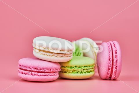 Macaroons on pink background. Colorful small cookie from ground almonds and coconut. Popular confectionery. Tasty snack food for take away, copy space macaroons, macaroon, macaron, pink, colorful, confectionery, cookie, popular, copy space, cake, pastry, cupcake, shortcake, tasty, food, design, snack, take, away, ground, almonds, coconut, small, red, studio, bunch, green, beige, dessert, pastel, different, assorted, cuisine, cafe, vintage, bakery, candy, sweet, french, sandwich, color, desert, sweetness, honey, goody, flavor, gourmet, breakfast, high-calorie, delicious