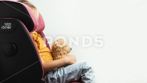 Cute little caucasian girl fastened with a belt in a Britax Romer safety car seat with sict isolated on white background. Kid safety while traveling by car. adorable, adventure, auto, automobile, bear, britax, britax romer, car, care, caucasian, chair, child, childhood, cute, driving, fasten, fun, girl, happiness, happy, holiday, isolated on white, kid, laugh, lifestyle, little, passenger, play, plush, portrait, protect, protection, safe, safety, seat, security, sict, side impact protect, sitting, stuffed, teddy, teddy bear, toddler, toy, transport, transportation, travel, vehicle, white, white background