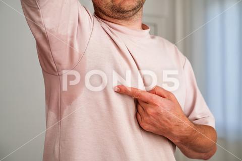 Man with hyperhidrosis sweating very badly under armpit. Hot weather. human, armpit, problem, sweat, sweaty, man, shirt, deodorant, hyperhidrosis, wet, hygiene, sweating, underarm, adult, disgust, showing, spot, stain, embarrassment, soaked, health, body, odor, portrait, smell, stinky, young, heat, arm, businessman, condition, excessive, perception, pit, stink, grey, partial, antiperspirant, caucasian, perspiration, perspire, prevent, skin, treatment, unpleasant, dirty, smelly, stress