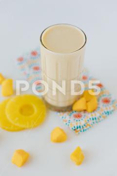 A vertical shot of the Pineapple Protein Shake background, berry, beverage, breakfast, calories, cocktail, cold, dessert, diet, drink, fat, food, fresh, fruit, fruits, glasses, healthy, ingredient, jar, juice, milk, milkshake, nourishment, nutrition, pineapple, pink, protein, raspberry, refreshment, shake, smoothie, sweet, vertical, yellow, yogurt