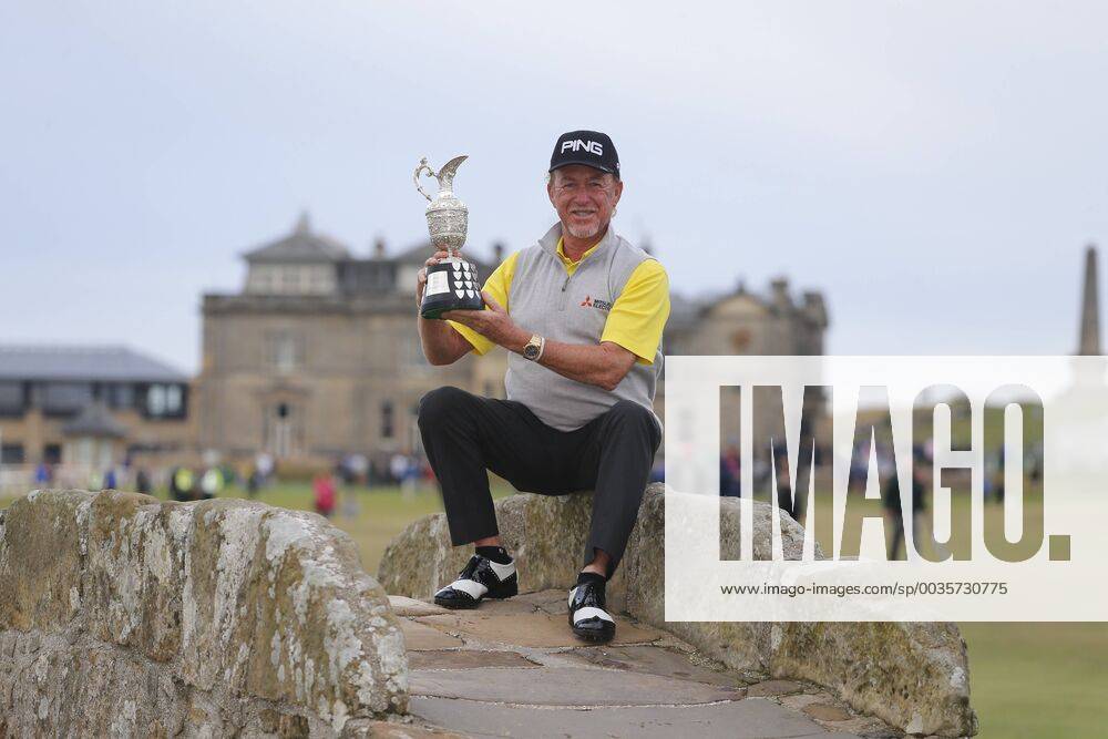 29th July 2018, Old Course at St Andrews, St Andrews, Scotland; The 2018 Senior Open Golf Championships, 4th round; This year s winner Miguel Angel Jimenez (ESP) poses with the Senior Open trophy on the Swilken Bridge on the 18th hole of the Old course ActionPlus12051762 AlanxMartin