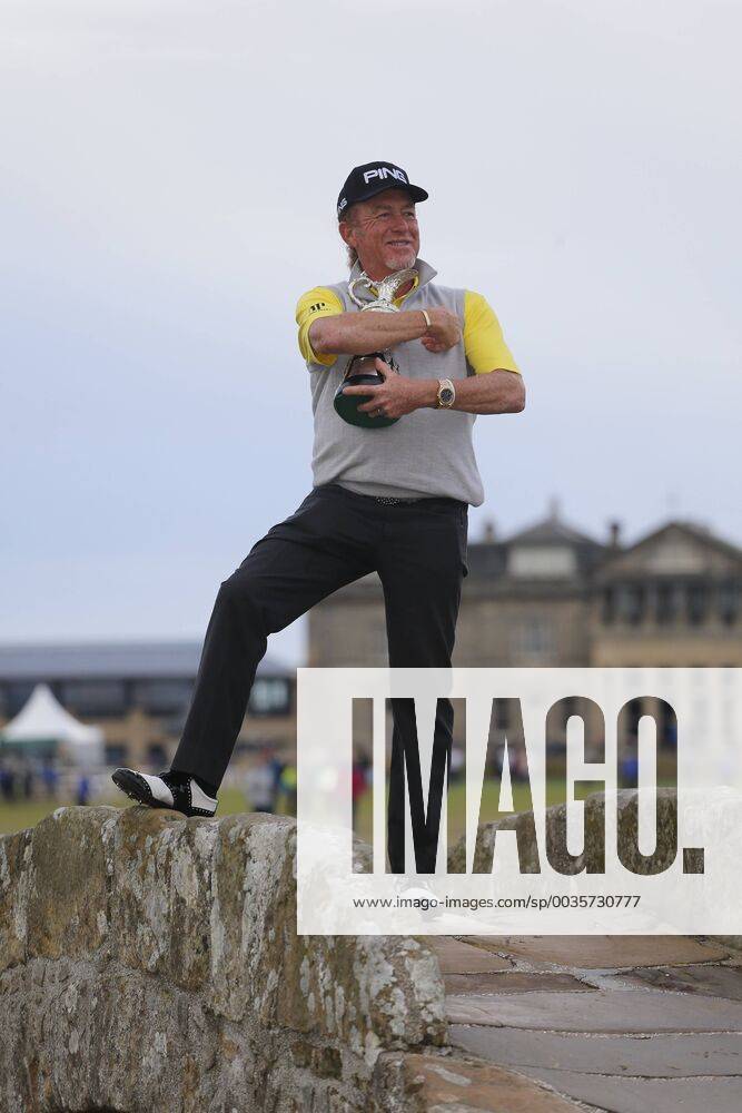 29th July 2018, Old Course at St Andrews, St Andrews, Scotland; The 2018 Senior Open Golf Championships, 4th round; This year s winner Miguel Angel Jimenez (ESP) poses with the Senior Open trophy on the Swilken Bridge on the 18th hole of the Old course ActionPlus12051764 AlanxMartin