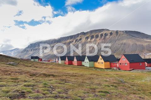Colorful houses in the Longyearbyen settlement on the island of Spitsbergen, Svalbard, Norway Color, Midnight sun, architecture, arctic, attraction, beautiful, cabin, cold, colorful, cottage, cruise, dwelling, europe, famous, freeze, frozen, house, houses, hut, lodge, miner, mountain, nordic, north, norway, norwegian, outdoor, peak, polar, pole, popular, postcard, poster, quaint, row, scandinavia, settlement, sight, sightseeing, solstice, spitsbergen, svalbard, tourism, tourist, town, travel, village, wooden