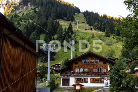 Cable car to Lake Oeschinen in SWITZERLAND EUROPE - - KANDERSTEG, SWITZERLAND EUROPE - JULY 14, 2022 nature, lake, switzerland, blue, landscape, kandersteg, sky, water, mountain, swiss, scenery, outdoor, tourism, green, europe, view, alps, oeschinensee, travel, rock, hiking, holiday, beautiful, bernese, scenic, scene, tree, stunning, background, oeschinen, idyllic, oberland, range, natural, hilly, rocky, panorama, amazing, photo, place, journey, majestic, turquoise, wanderlust, wonderful, alpine