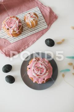 Happy Easter cake with sprinkles on glaze. Cake on light rustic board. Homemade bakery cake, traditional, egg, branches, symbol, card, pastry, baked, natural, cooking, icing, decor, celebrate, easter eggs, holiday cake, love, willow branches, seasonal, copy space, concept, easter cake, dessert, orthodox, gourmet, decoration, colorful, christian, easter decor, table, sweet, easter decorations, multicolored, homemade, branch, fresh, willow, ribbon, rustic, holiday, decorative, delicious, easter, festive, season, april, pink, blue, springtime, happy