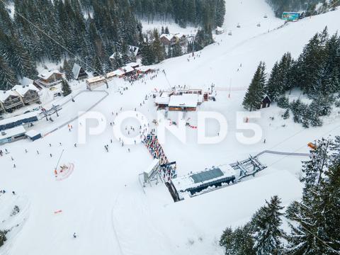Aerial view jasna ski resort lines to chair lift copy space mountains, travel, aerial, mountain, mount, mountains range, peak, top, drone, overhead, top view, directly above, above, snowboarding, skiing, ski, helmet, goggles, ski goggles, season, sport, activities, extreme, snow, snowing, snowed, white, frost, cold, landscape, scenic, nature, beauty in nature, rural, panoramic, chairlift, chair lift, line, crowd, slovakia, jasna, ski resort, tatra
