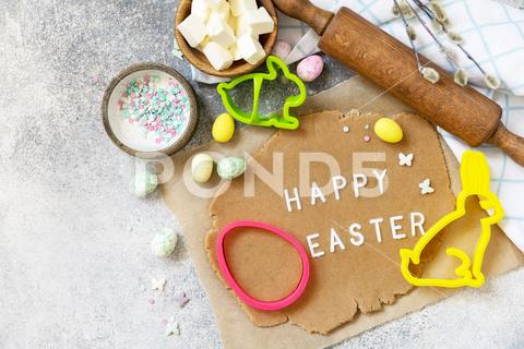 Background for baking or cooking Easter cookies. Ingredients and kitchen utensils for baking on a light stone table. View from above. Copy space. easter, background, template, easter egg, sweet, food, bakery, table, recipe, cake, spring, kitchen, egg, pastry, cooking, dessert, flour, menu, preparation, culinary, homemade, holiday, top, view, celebration, above, dough, traditional, bread, bake, wooden, baking, sugar, cookie, flat lay, meal, cooked, frame, utensils, nut, copy, rabbit, festive, bakers, butter, cookies, ingredients, christian, brioche