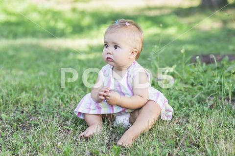 Adorable baby in multicolored dress in the park. young, joy, meadow, green, happy, hair clip, hairstyle, nature, small, dress, blonde, girl, cute, beautiful, kid, adorable, toddler, childhood, beauty, infant, caucasian, daughter, pretty, lovely, style, sweet, eyes, barefoot, fashionable, stylish, preschooler, person, expression, fashion, park, garden, lawn, grass, sit, diaper, newborn, portrait, stroll, Kindergarten, denmark, scandinavian, north