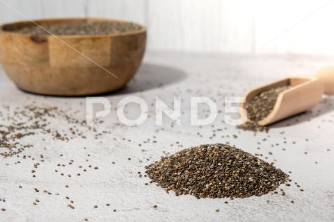 Heap of Chia seeds with wooden spoon. Healthy superfood rich in Omega 3 fatty acids. Dry healthy natural ingredient. Chia grains are falling. Vegetarian food ketogenic, cholesterol, seed, supplement, grain free, dieting, protein, chia seeds, earthy, close-up, food, antioxidant, agriculture, vegetarian, ingredient, breakfast, nutrition, dry, heap, amino acid, wooden, supplements, nutritious, backgrounds, chia seed, copy space, vegetarian food, organic, chia grains, chia, bean, raw food, diet, ingredients, health benefits, natural, nutritional supplement, raw, omega-3, healthy, macro, healthy eating, cereal plant, background, closeup, cellulose, health, superfood, bowl