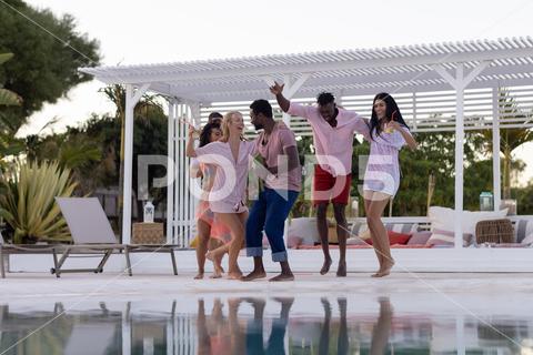 Happy diverse friends having party by swimming pool, dancing. Spending quality time, lifestyle, friendship, summertime and vacation concept. Medium Group Of People, Young Adult, Woman, Female, White, Black, Multiracial, Mid Adult, Man, Male, People, Happy, Diverse, Friend, Swimming Pool, Dancing, Spending, Quality Time, Lifestyle, Friendship, Party, Summertime, Vacation, Concept, Young, Fun, Holiday, Person, Leisure, Happiness, Together, Cheerful, Smile, Adult, Beautiful, Summer, Celebration, Friends, Portrait, Smiling, Attractive, Cute, Joy, Swimming, Pool, Quality, Time